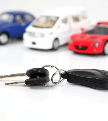 A car key with several other cars behind it.